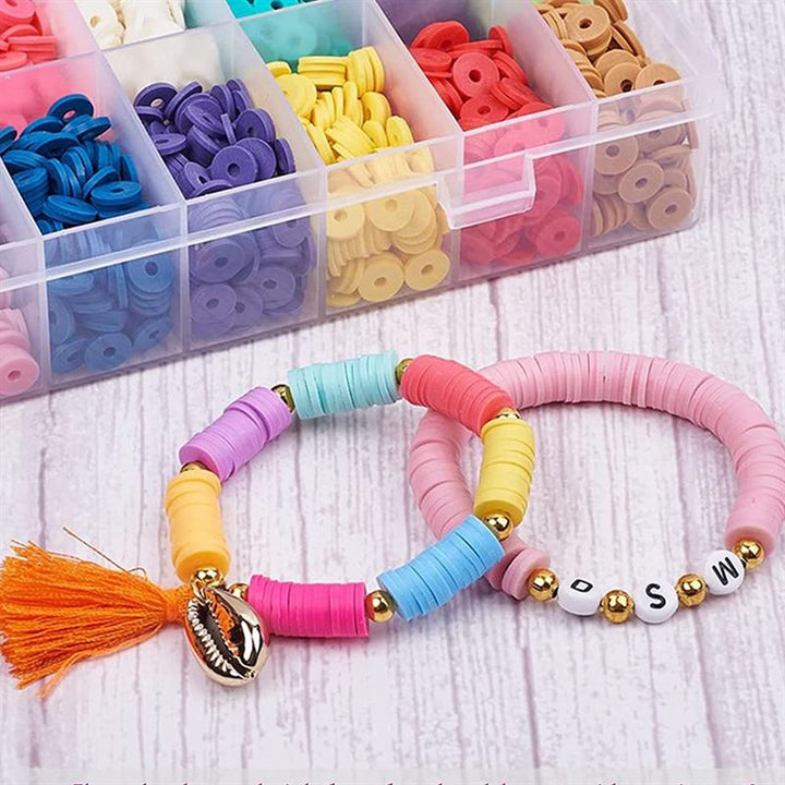 Two vibrant bracelets crafted with Fashiongirl’s KREA DIY Acrylic bead jewellery set lie beside its 24-compartment box of bright beads. One bracelet features an orange tassel and shell charm; the other spells BSW with white letter beads on a wooden surface.