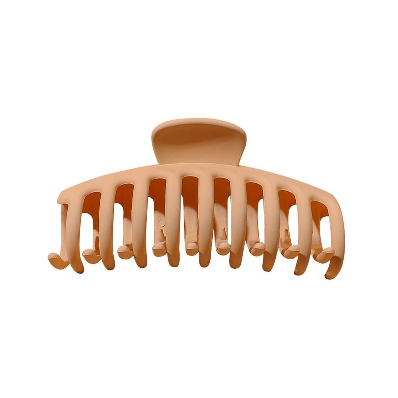 The SOHO Kana Hair Claw - Sepia by SOHO features a tan plastic design with wide, curved teeth for a strong grip, suitable for all hair types. Shown against a white background.
