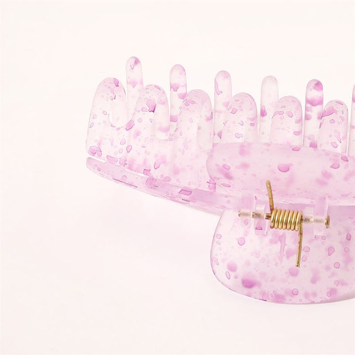 The SOHO Kana Splash Hair Claw - Purple is a translucent pink claw with purple spots, water droplet patterns, a gold spring, and strong grip. Shown on a plain white background. Suitable for all hair types.