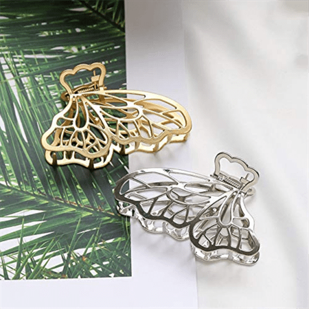 The SOHO Metal Butterfly Hair Claw in silver by SOHO features an elegant design, providing a secure hair grip. Photographed on a green palm leaf print, it adds shine and style to your look.