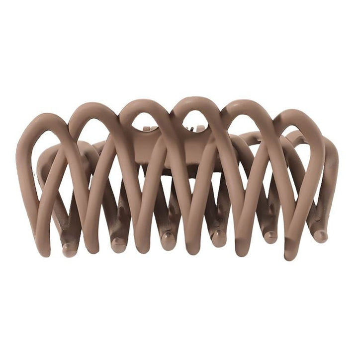 The SOHO Olive Hair Claw - Brown by SOHO features interlocking curved prongs for a gentle grip on all hair types. Shown from the side against a white background.