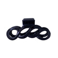 The SOHO Wave Hair Claw - Black by SOHO features an open, swirled loop design and a spring-loaded clasp for a strong grip and secure styling.