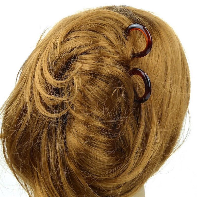 A close-up of the back of a persons head with light brown hair styled in a twist, secured neatly by SOHO Twist Chignon Hairpins pack of 3.