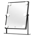 Der UNIQ XL Hollywood Mirror mit LED-Beleuchtung und Touch-Steuerung von UNIQ verfügt über einen eleganten schwarzen Rahmen, sechs runde LED-Leuchten und einen Touch-Netzschalter. Er wird mit einem stabilen Ständer geliefert und eignet sich somit perfekt für Ihre Make-up-Routine.